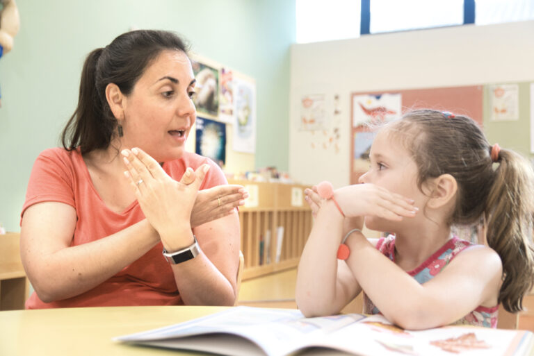 Sign language teacher in a classroom with a child